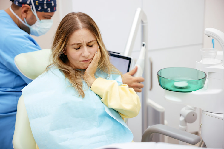a photo of a lady in a dental emergency situation with a broken tooth