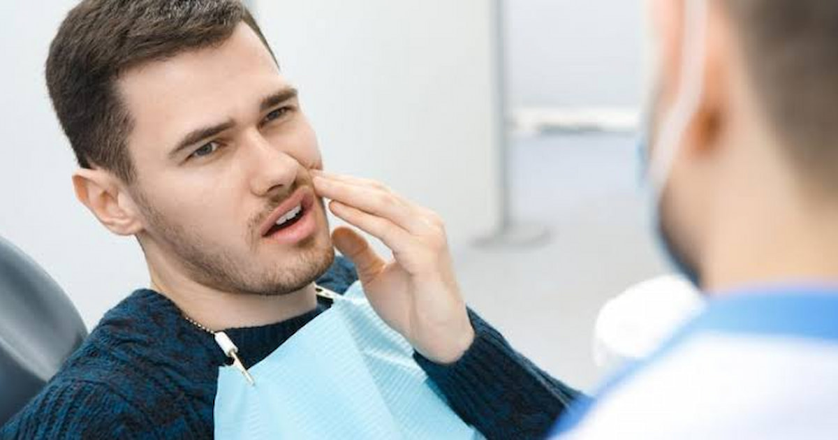 a photo of a man with tooth abscess symptoms