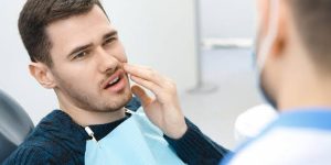 a photo of a man with tooth abscess symptoms